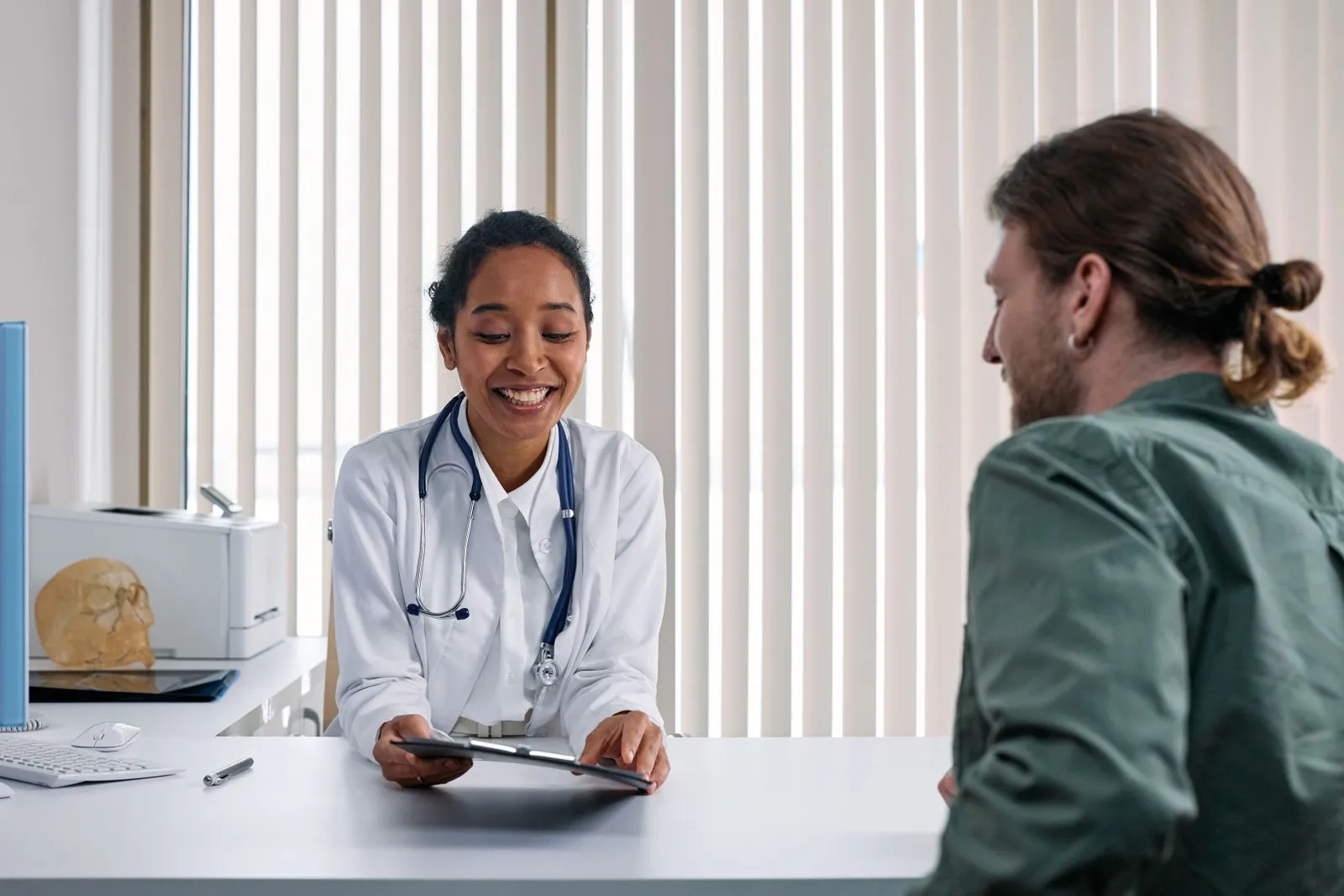 A clinician and patient in a warm, reassuring consultation