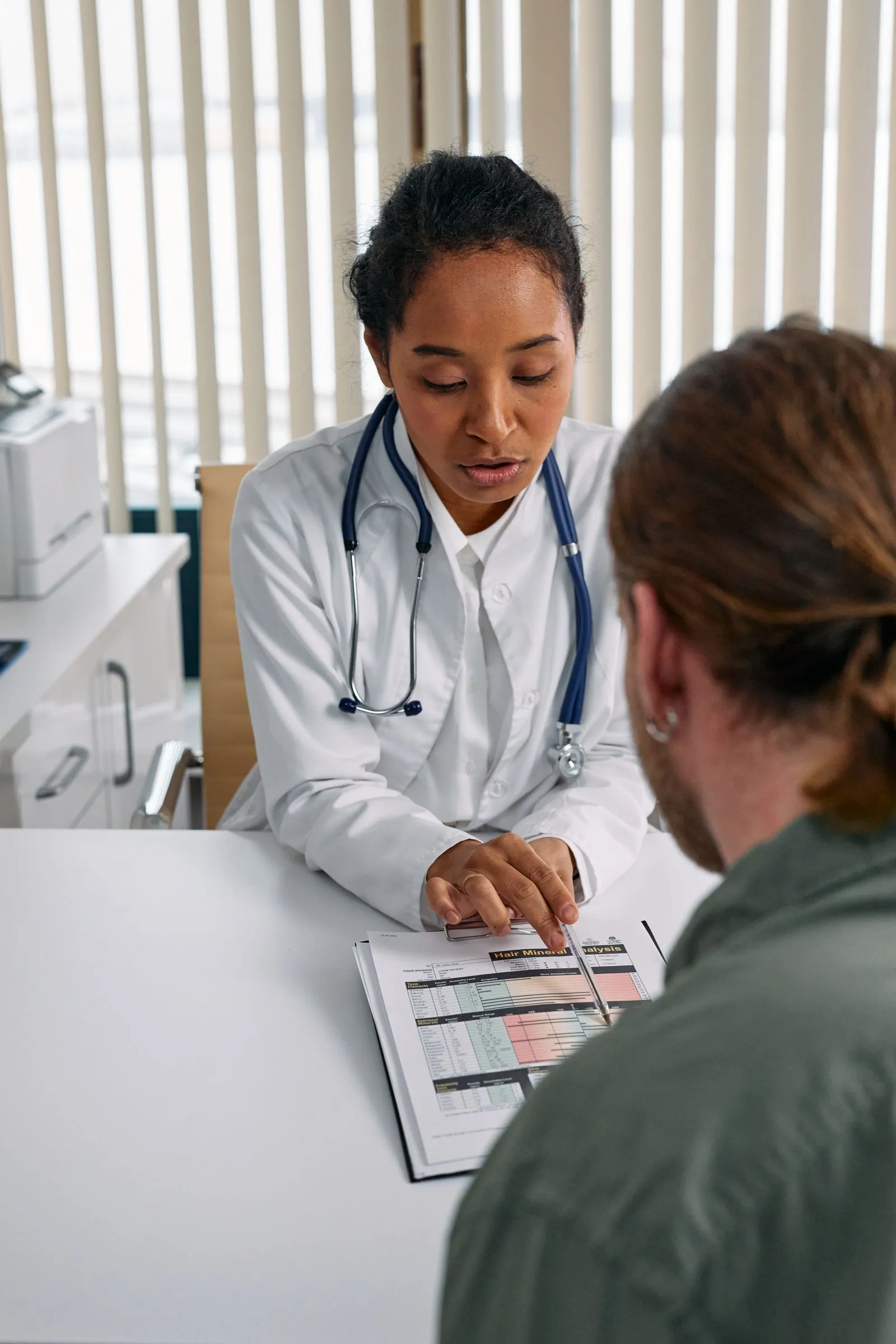 A doctor reviewing health information warmly with a patient